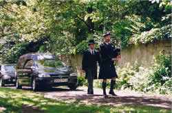highland piper at a funeral