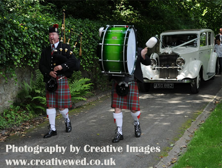 Piper marching with wedding car